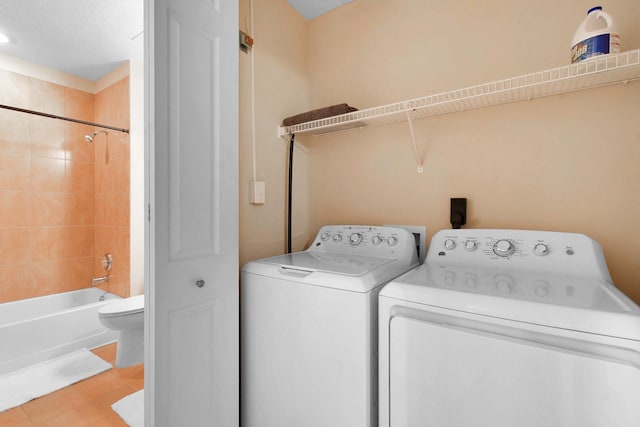 washroom featuring washer and dryer and light tile patterned floors