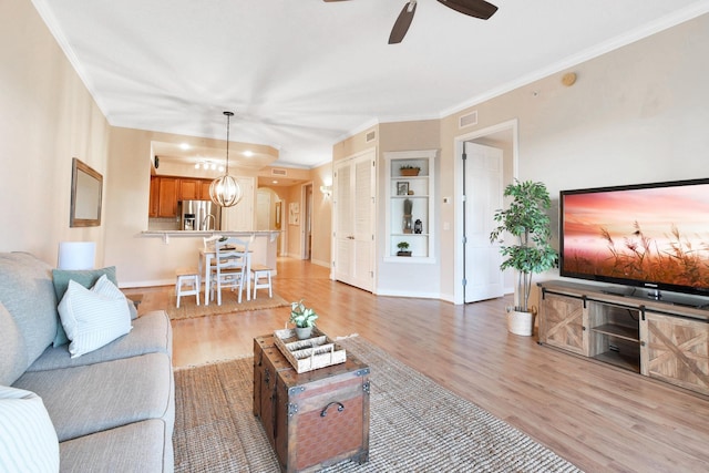 living room featuring ceiling fan, light hardwood / wood-style floors, and ornamental molding