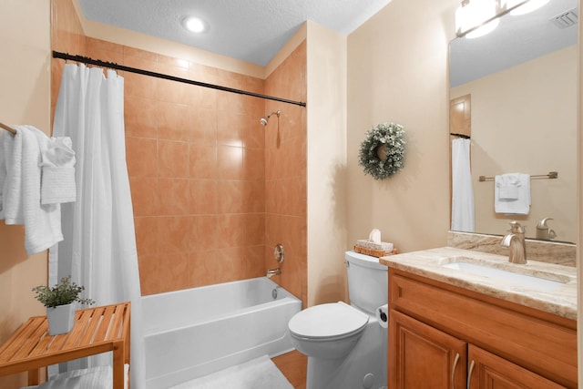 full bathroom featuring vanity, toilet, shower / bathtub combination with curtain, and a textured ceiling