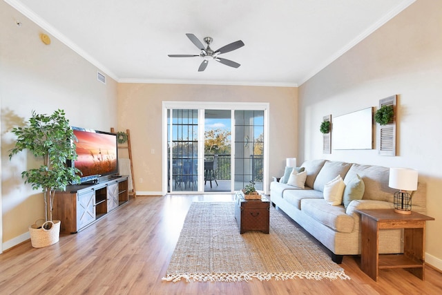 living room with hardwood / wood-style flooring, ceiling fan, and ornamental molding