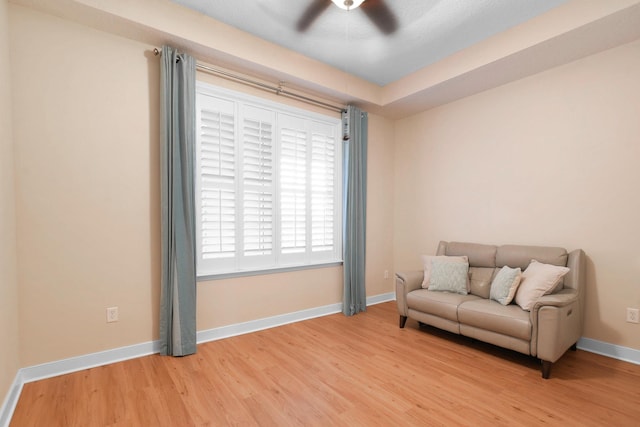 sitting room featuring ceiling fan and light hardwood / wood-style floors