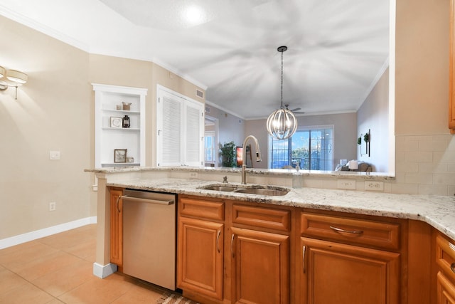 kitchen featuring tasteful backsplash, stainless steel dishwasher, sink, pendant lighting, and a chandelier