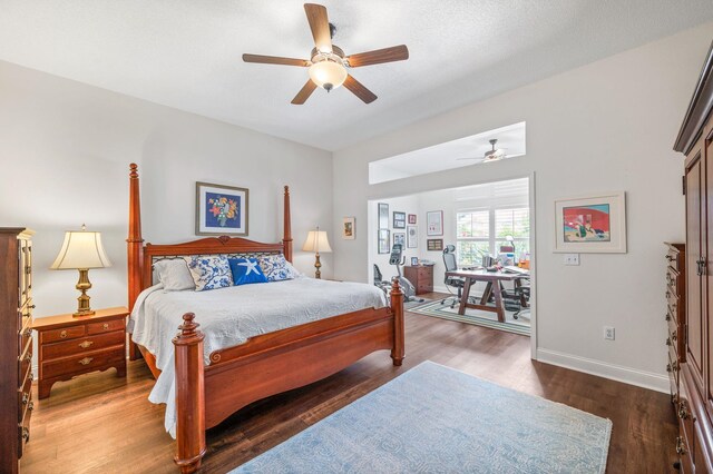 bedroom with dark hardwood / wood-style flooring and ceiling fan