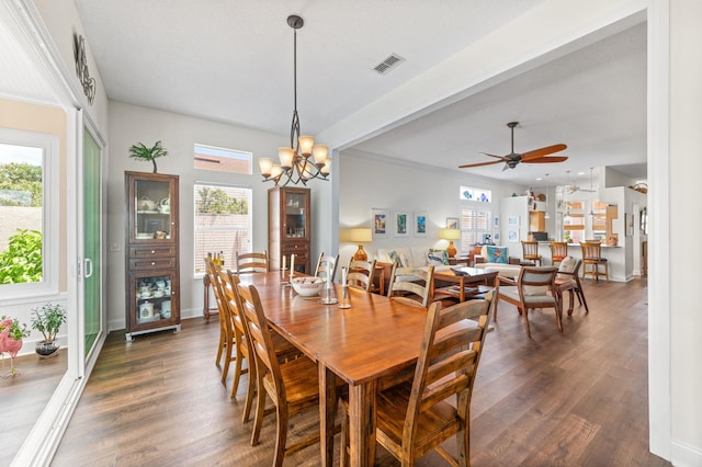 dining area with beamed ceiling, ceiling fan with notable chandelier, dark hardwood / wood-style flooring, and ornamental molding