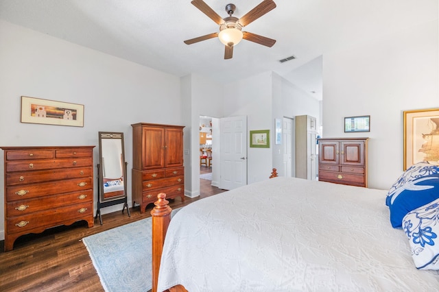 bedroom with a high ceiling, ceiling fan, and dark wood-type flooring