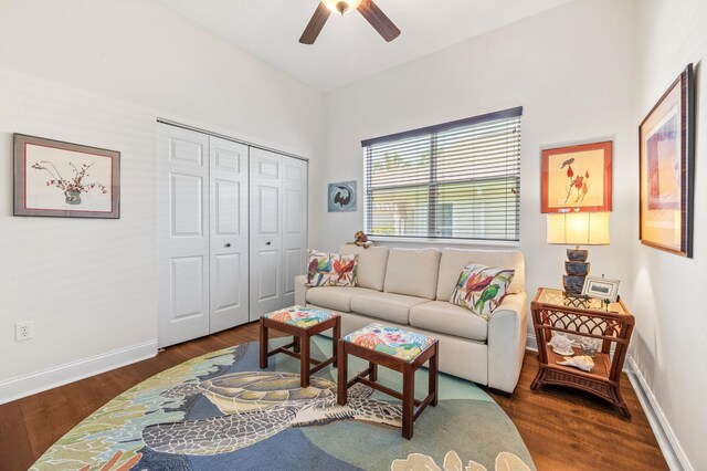 living room with ceiling fan and dark hardwood / wood-style flooring