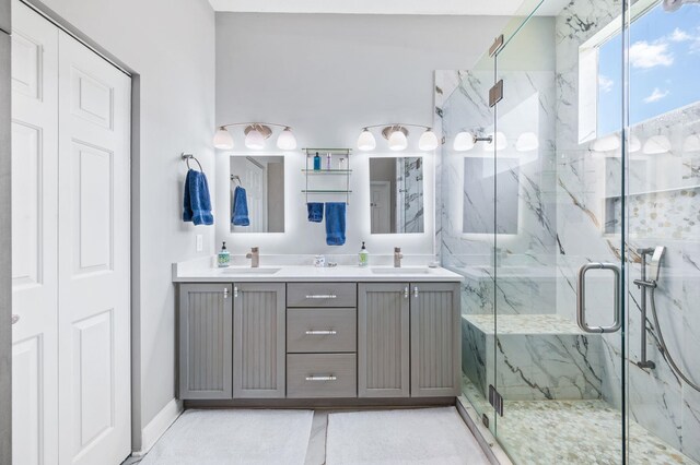 bathroom featuring vanity and a shower with door