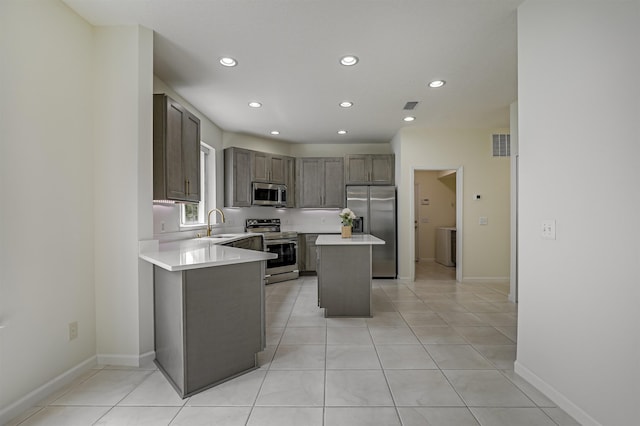 9162 August Cir, Saint Augustine, FL 32080 - kitchen featuring stainless steel appliances, light countertops, recessed lighting, a kitchen island, and washer / clothes dryer