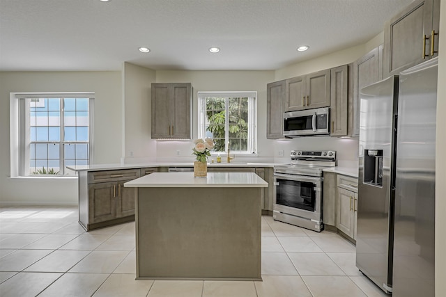 9162 August Cir, Saint Augustine, FL 32080 - kitchen featuring stainless steel appliances, light countertops, recessed lighting, a kitchen island, and light tile patterned floors