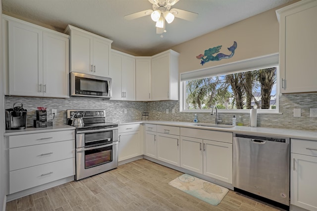 9162 August Cir, Saint Augustine, FL 32080 - kitchen with stainless steel appliances, light countertops, a ceiling fan, tasteful backsplash, and white cabinets
