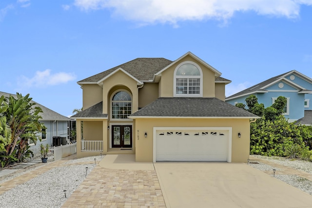 9162 August Cir, Saint Augustine, FL 32080 - traditional home featuring french doors, stucco siding, concrete driveway, and an attached garage