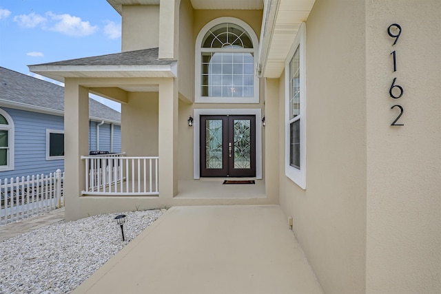 9162 August Cir, Saint Augustine, FL 32080 - property entrance featuring stucco siding, french doors, and roof with shingles