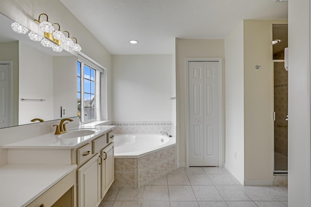 9162 August Cir, Saint Augustine, FL 32080 - full bath featuring vanity, tile patterned flooring, a garden tub, a closet, and a stall shower