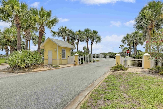 9162 August Cir, Saint Augustine, FL 32080 - view of asphalt road with a gate, curbs, and a gated entry