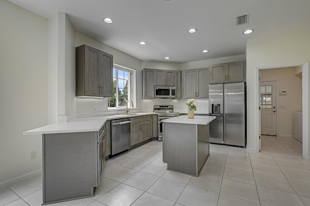 9162 August Cir, Saint Augustine, FL 32080 - kitchen featuring appliances with stainless steel finishes, light countertops, recessed lighting, gray cabinetry, and light tile patterned floors
