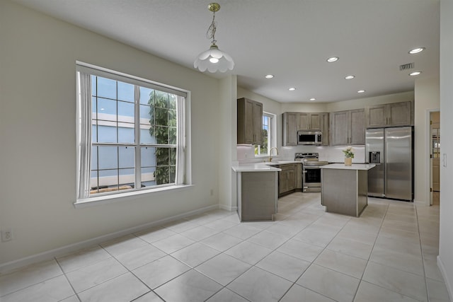 9162 August Cir, Saint Augustine, FL 32080 - kitchen featuring appliances with stainless steel finishes, light countertops, recessed lighting, light tile patterned floors, and hanging light fixtures