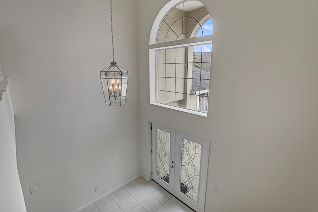 9162 August Cir, Saint Augustine, FL 32080 - foyer featuring a towering ceiling, a chandelier, french doors, and light tile patterned flooring