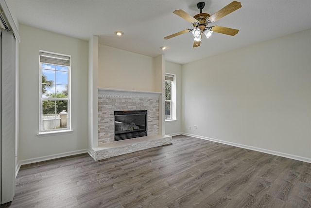 9162 August Cir, Saint Augustine, FL 32080 - unfurnished living room featuring wood finished floors, a glass covered fireplace, recessed lighting, and a ceiling fan