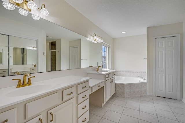 9162 August Cir, Saint Augustine, FL 32080 - bathroom with tile patterned flooring, a garden tub, vanity, and a closet