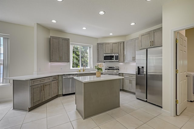 9162 August Cir, Saint Augustine, FL 32080 - kitchen with stainless steel appliances, a peninsula, light countertops, recessed lighting, and a kitchen island
