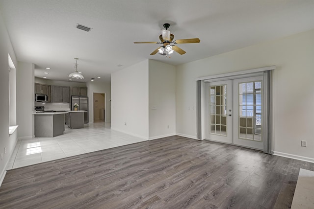 9162 August Cir, Saint Augustine, FL 32080 - unfurnished living room featuring light wood finished floors, a ceiling fan, french doors, and recessed lighting