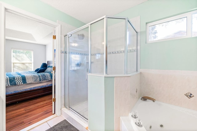 bathroom with a textured ceiling, tile patterned floors, and separate shower and tub