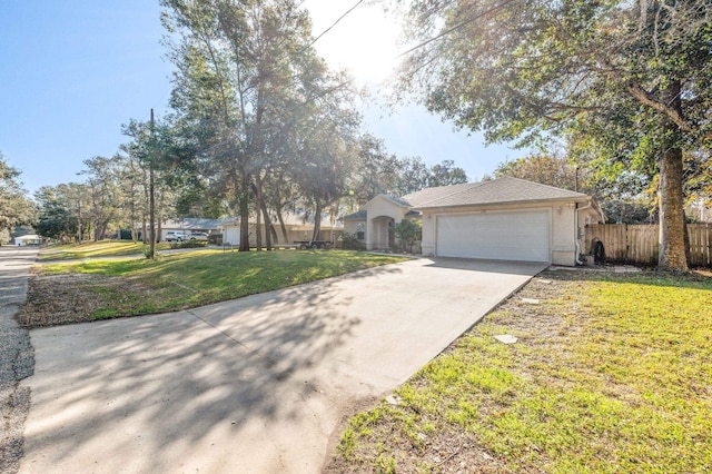 ranch-style house featuring a garage and a front lawn