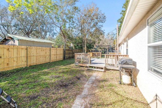 view of yard with a wooden deck