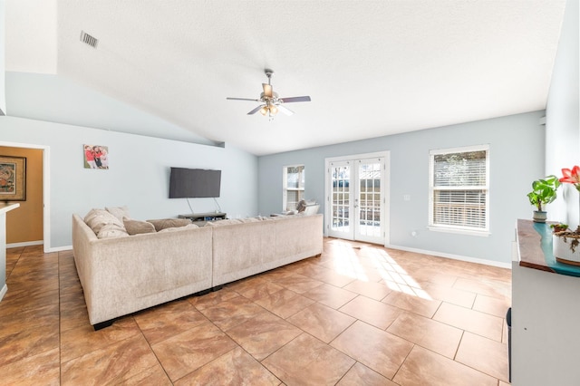 living room featuring light tile patterned flooring, lofted ceiling, ceiling fan, and french doors