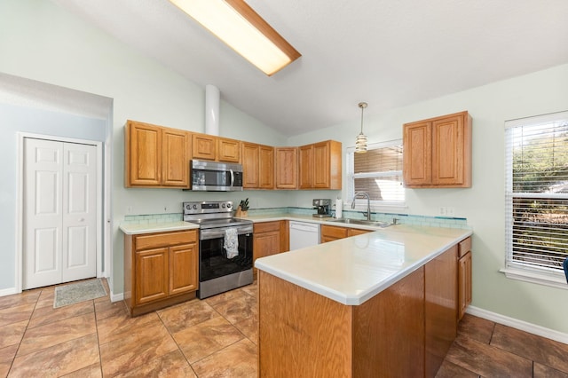 kitchen featuring pendant lighting, sink, appliances with stainless steel finishes, a healthy amount of sunlight, and kitchen peninsula