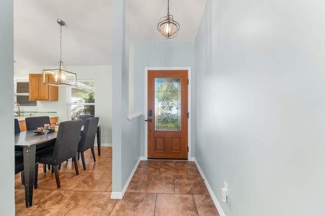 entrance foyer with a notable chandelier and sink