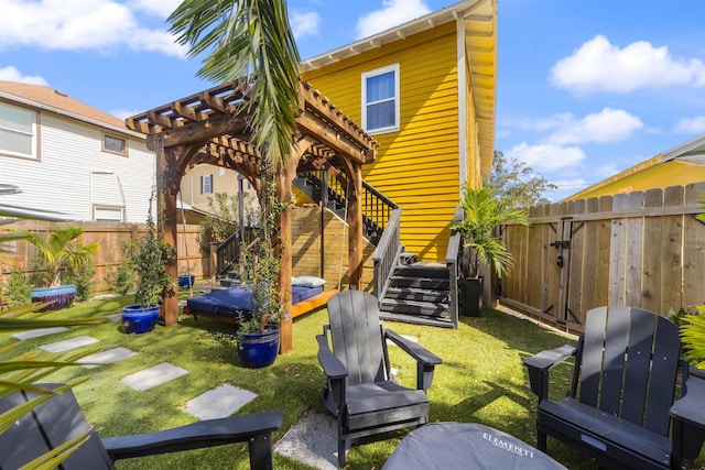 rear view of property with a yard and a pergola