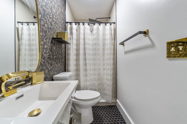 bathroom featuring tile patterned flooring, curtained shower, toilet, and sink