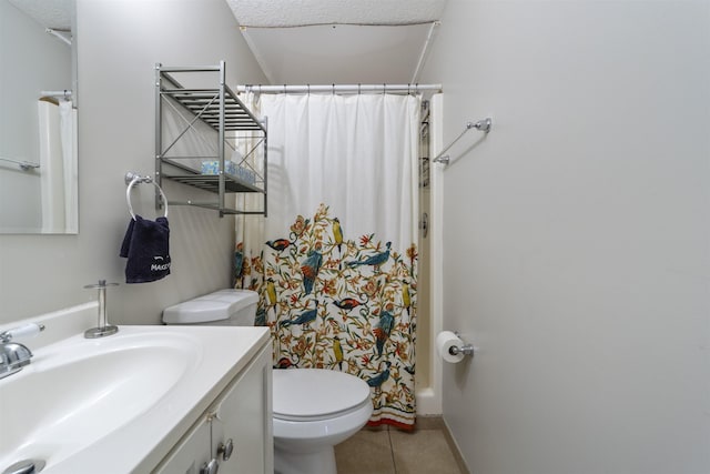 bathroom featuring tile patterned flooring, vanity, toilet, and a textured ceiling