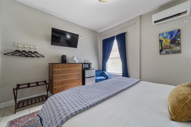 bedroom featuring a wall unit AC, light tile patterned floors, and fridge