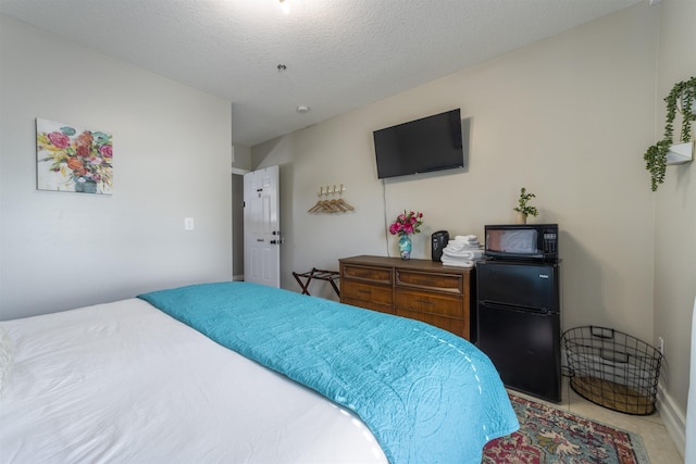 2 Mulvey St, Saint Augustine, FL 32084 - bedroom featuring freestanding refrigerator and a textured ceiling