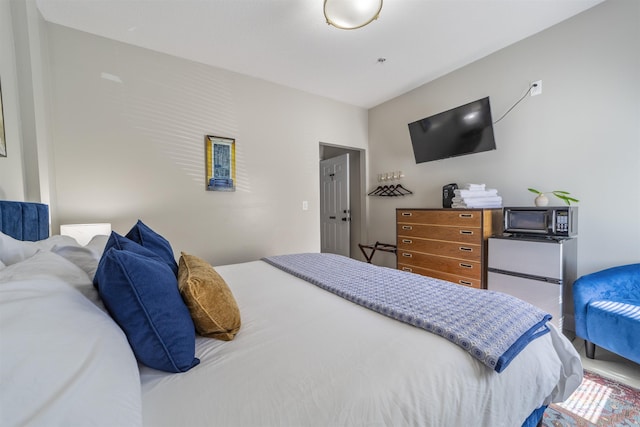 bedroom featuring fridge