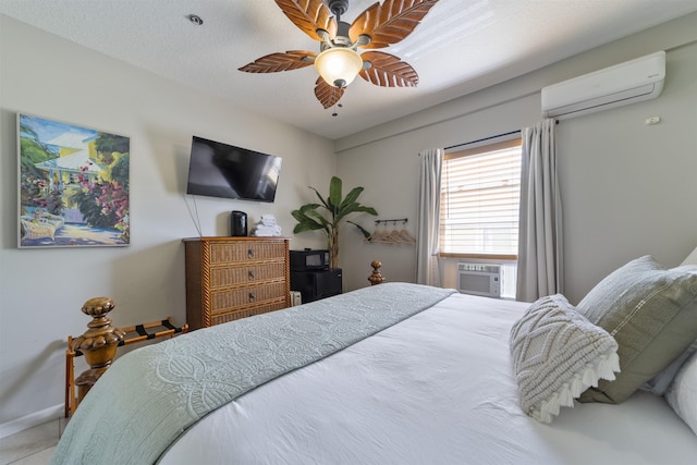 bedroom with ceiling fan, cooling unit, a textured ceiling, and a wall unit AC