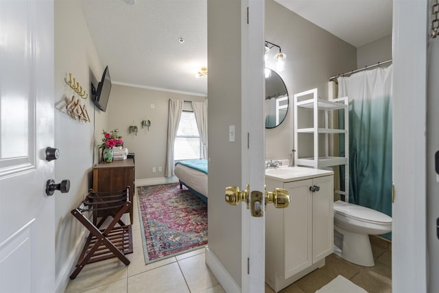 bathroom featuring toilet, a textured ceiling, vanity, and tile patterned floors