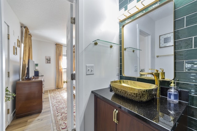 bathroom with vanity, hardwood / wood-style floors, and a textured ceiling