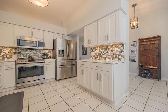 kitchen with backsplash, white cabinets, stainless steel appliances, and decorative light fixtures