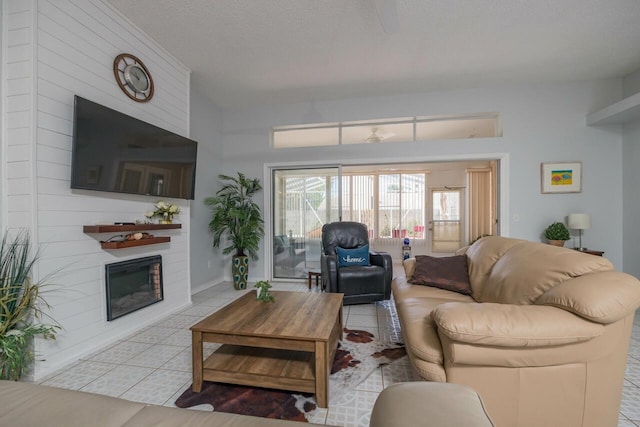 living room with light tile patterned floors and a textured ceiling