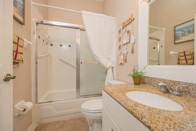 full bathroom featuring tile patterned flooring, toilet, combined bath / shower with glass door, and vanity