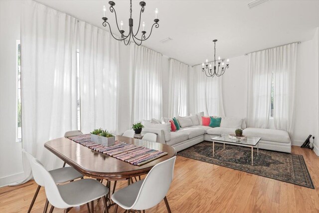 91 Oneida St, Saint Augustine, FL 32084 - dining area with wood finished floors, a notable chandelier, and baseboards