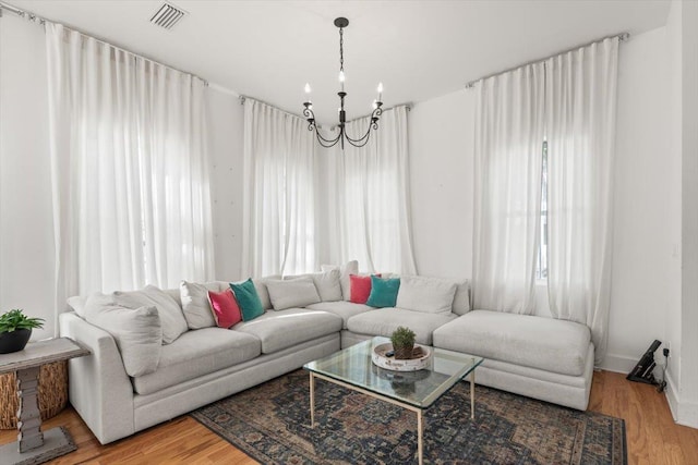 91 Oneida St, Saint Augustine, FL 32084 - living room featuring a chandelier, wood finished floors, and plenty of natural light