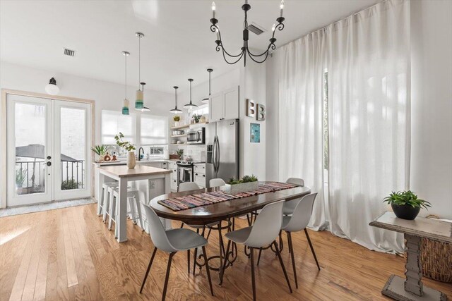 91 Oneida St, Saint Augustine, FL 32084 - dining room featuring french doors, light wood finished floors, and visible vents