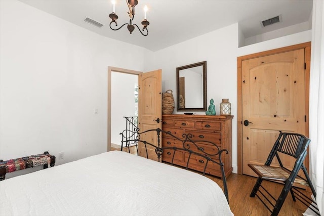 91 Oneida St, Saint Augustine, FL 32084 - bedroom with visible vents, an inviting chandelier, and wood finished floors