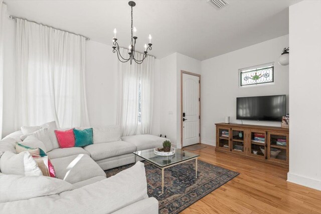 91 Oneida St, Saint Augustine, FL 32084 - living room featuring a chandelier, visible vents, baseboards, and wood finished floors