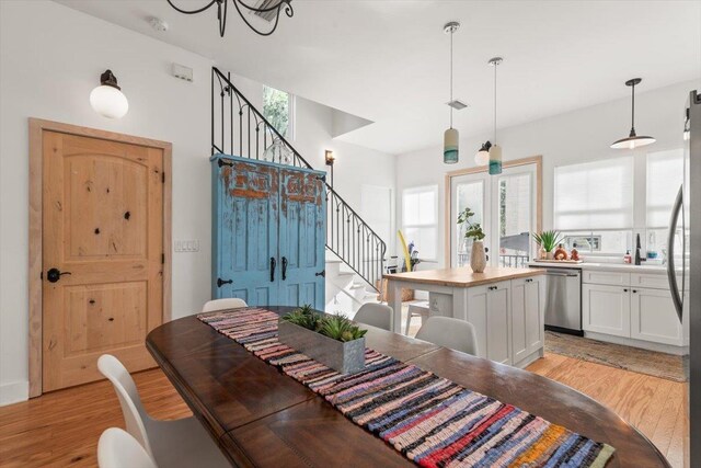 91 Oneida St, Saint Augustine, FL 32084 - dining room with visible vents, a chandelier, light wood-style floors, and stairs