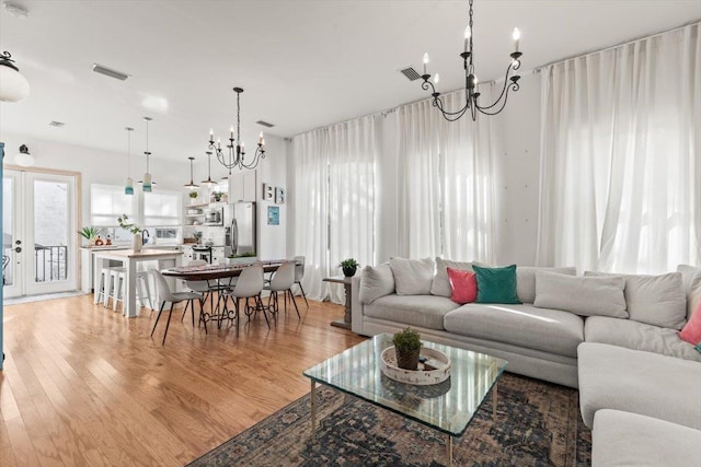 91 Oneida St, Saint Augustine, FL 32084 - living room featuring a notable chandelier, light wood-type flooring, and visible vents